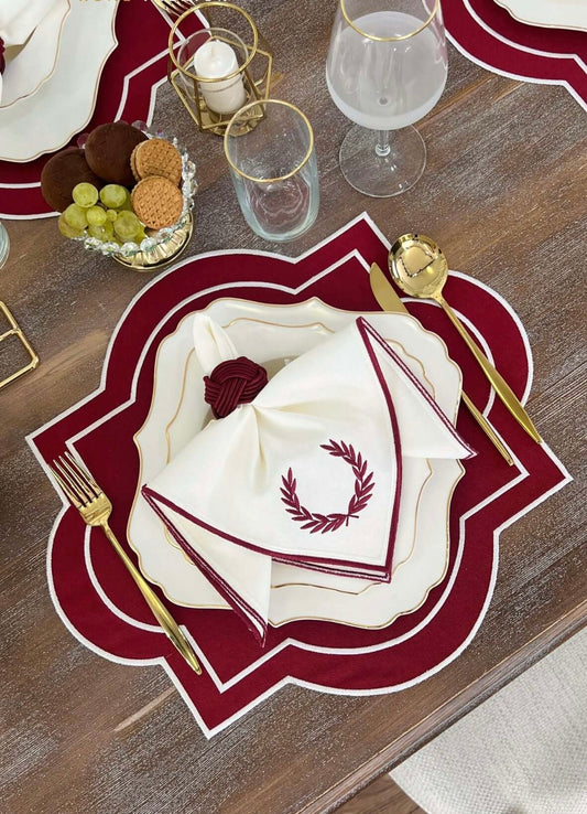 Red and white embroidered Milan Design table set with gold-accented cutlery and plates. Perfect for a stylish dining setup for 6 people.